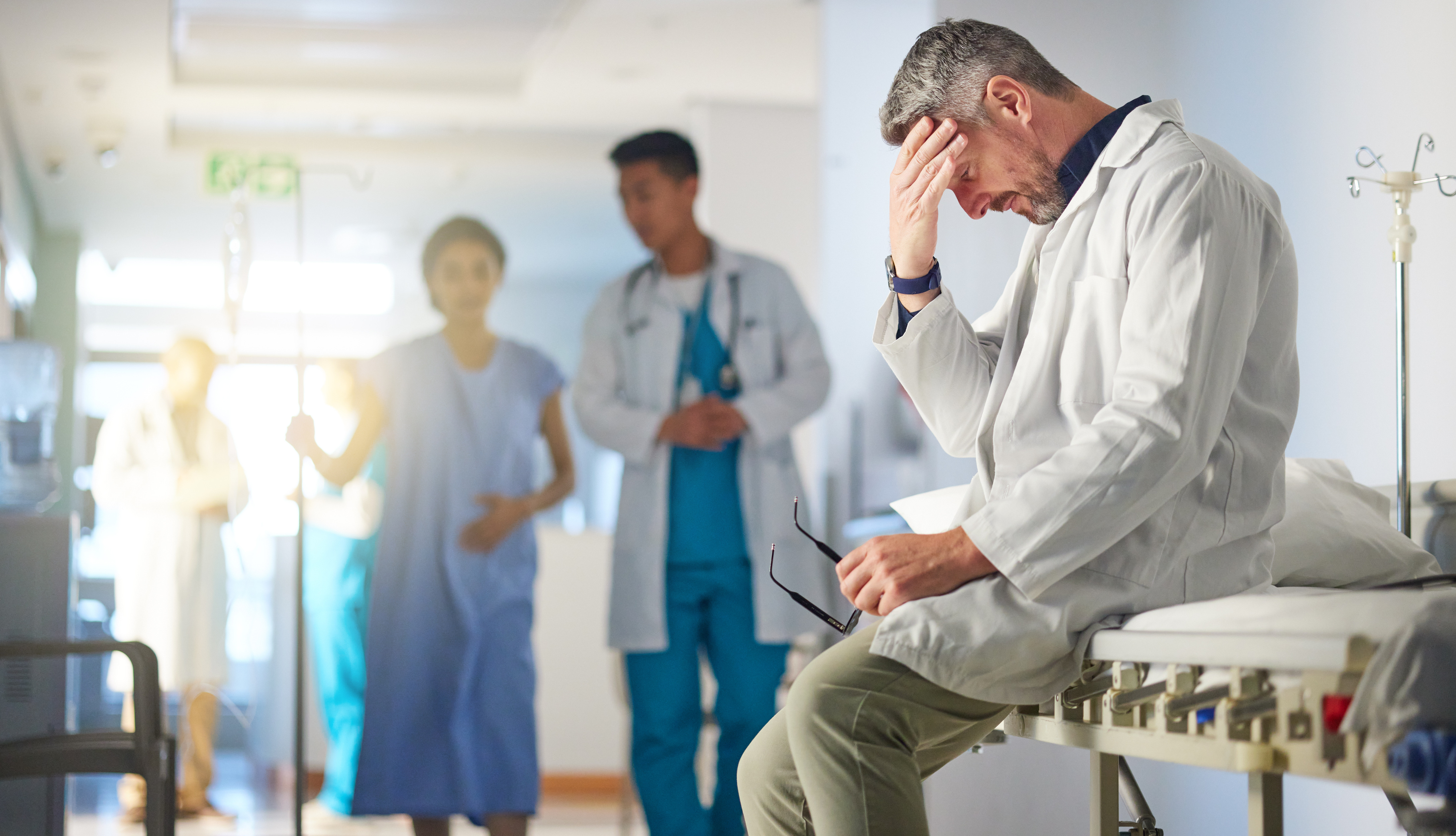 Senior doctor experiencing stress and frustration in a hospital setting